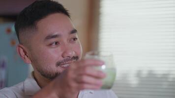 Relaxed scenes of man sipping homemade matcha latte at home. Natural lifestyle moments showing calmness, daily ritual, and enjoyment of a traditional green tea drink talk video