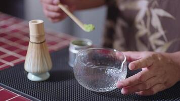 Preparing Matcha Tea Latte at home from measuring, whisking with a bamboo chasen, and pouring into a glass, capturing the soothing ritual of making this traditional Japanese drink. pour powder video