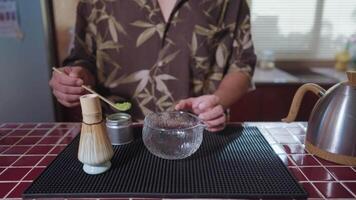 Preparing Matcha Tea Latte at home from measuring, whisking with a bamboo chasen, and pouring into a glass, capturing the soothing ritual of making this traditional Japanese drink. powder to video