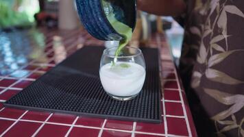 Preparing Matcha Tea Latte at home from measuring, whisking with a bamboo chasen, and pouring into a glass, capturing the soothing ritual of making this traditional Japanese drink. slow green matcha video
