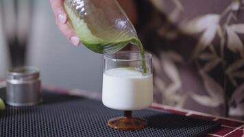 Preparing Matcha Tea Latte at home from measuring, whisking with a bamboo chasen, and pouring into a glass, capturing the soothing ritual of making this traditional Japanese drink. matcha to milk video
