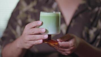 Preparing Matcha Tea Latte at home from measuring, whisking with a bamboo chasen, and pouring into a glass, capturing the soothing ritual of making this traditional Japanese drink. glass on hand video
