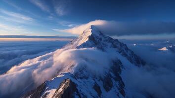 Majestic Mountain Peak Emerging From Clouds at Dawn with Blue Sky photo