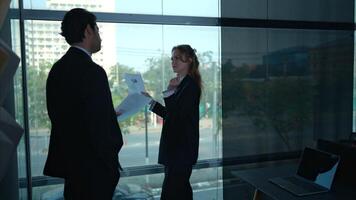 In the office, two businessmen and women discuss and exchange idea and give advice to each other to complete the work,20 photo