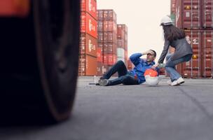 First aid for a container warehouse worker fainted while working in the bright sunlight and hot weather of a container storage yard,161 photo