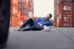 A worker in a container warehouse fainted while working in the bright sunlight and hot weather of a container storage yard,150 photo