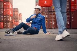First aid for a container warehouse worker fainted while working in the bright sunlight and hot weather of a container storage yard,118 photo