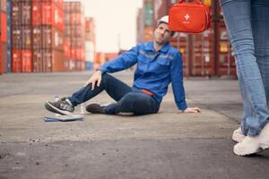 First aid for a container warehouse worker fainted while working in the bright sunlight and hot weather of a container storage yard,112 photo