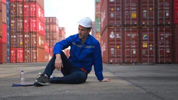 A worker in a container warehouse fainted while working in the bright sunlight photo