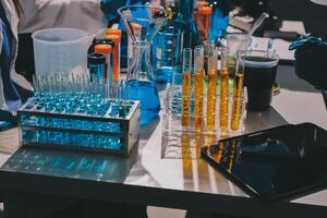 A table with several test tubes and a tablet photo