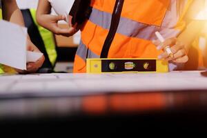 A construction worker is holding a measuring tape photo