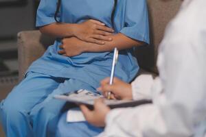 A doctor is writing on a patient's stomach photo