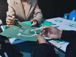 A man and woman are working on a paper with the words zerowaste photo