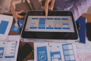 A person is using an ipad to show a design photo