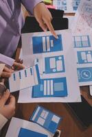 A man and woman are working on a design document photo