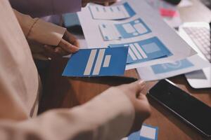 A person holding a piece of paper with a blue icon on it photo