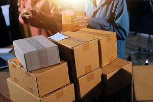 A man and woman are standing near a stack of boxes photo