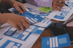 A group of people working on blue and white paper photo