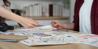 Collaborative Project Review. Young professionals engaged in a design discussion and idea sharing. photo