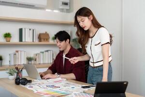 Design Collaboration. Young woman and man discussing UX UI concepts in a modern office. photo