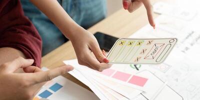 Hands Holding User Interface Design Concepts for Review photo