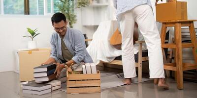 Gay couple organizing and unpacking boxes in their new home photo