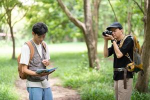 Father and Son Capturing Memories. Hiking with a camera and map. photo