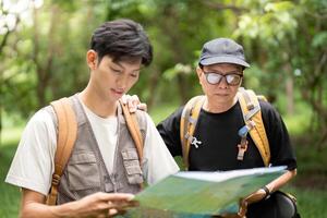 Father and Son Hiking Adventure. Exploring nature together with a map. photo