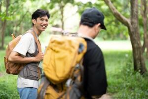 Joyful Hiking Experience. Son smiling at his father during their adventure. photo