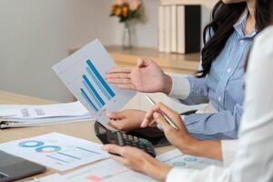 Data Presentation and Financial Insights. Professionals discussing financial graphs and reports. photo