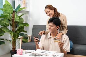 Smart Spending and Financial Awareness. Young couple discussing expenses with credit card. photo