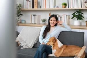 Comfort and Connection with Pets. Young woman relaxing with her dog while watching TV. photo