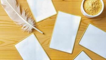 Creative Workspace With Empty Cards, Decorative Feather, and Small Bowl Filled With Yellow Powder photo