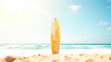 Surfboard Stands on Sandy Beach Under Blue Sky With Ocean Waves in Background photo