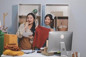 Two women in an office with a computer and a desk photo