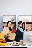 Two women are holding boxes photo