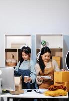 Two women standing at a desk photo