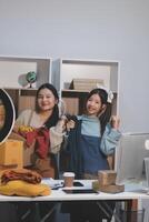 Two women are sitting at a desk photo