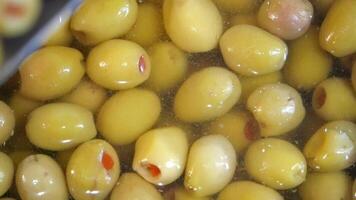 Green olives being brined in a large container video