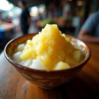 Serving Pineapple Dessert in Bowl on Wooden Table photo