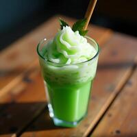 Refreshing Green Smoothie with Whipped Topping and Straw photo