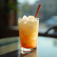 Refreshing Cold Drink with Ice and Straw on Table in Sunlight photo