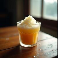 Refreshing Orange Juice with Creamy Topping in a Glass photo