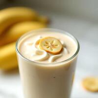 Preparing Banana Smoothie with Cream and Fruit Slice Topping photo