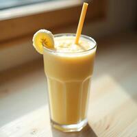 Banana Smoothie in Glass with Straw and Banana Slice photo