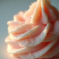 Close-up of Swirled Pink Frosting with Water Droplets photo