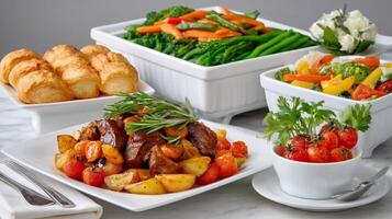 Catering service presenting a dish of beef stew with roasted potatoes and cherry tomatoes photo