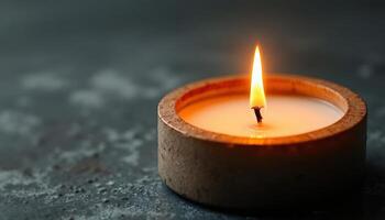 Burning candle in a decorative holder. Relaxing flame for meditation, aromatherapy, and a cozy home atmosphere. Warm light for spiritual concept. photo