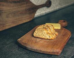 A minimalist arrangement of bread slices and cheese, ready to be served. Captured in a clean home kitchen with wooden elements. This image conveys simplicity, nourishment, and rustic charm photo