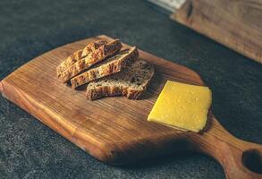 A step-by-step view of sandwich preparation with cheese and bread on a kitchen table. Natural textures and light create a warm, inviting image. Ideal for food blogs, recipe sites, or cooking photo